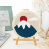 Mount Fuji art punch needle kit showing Japanese mountain embroidery design in wooden hoop with crafting