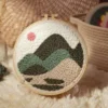 Mountain Landscape Punch Needle Starter Kit Mountain landscape punch needle starter kit featuring rolling hills and peaks design in wooden hoop with yarn and crafting tools