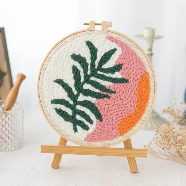 Punch needle kit showing peachy palm tree design in embroidery hoop with tropical colors and beginner crafting tools