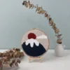 Mount Fuji art punch needle finished wall decor displayed on wooden easel with eucalyptus branches home styling
