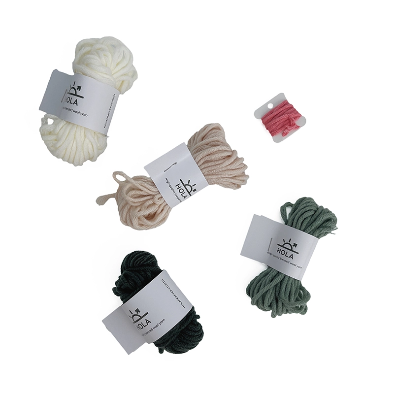 Punch needle starter kit yarn in white, beige, green, and black colors with HOLA brand labels for mountain landscape design