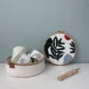Punch needle embroidery kit with wild leaves design, organized yarn supplies in woven basket, and wooden punch needle tool