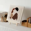 DIY Couple Gift Punch Needle Wall Art Kit Abstract Couple Design DIY couple gift punch needle wall art showing abstract couple silhouettes in earth tones on white fabric with easel