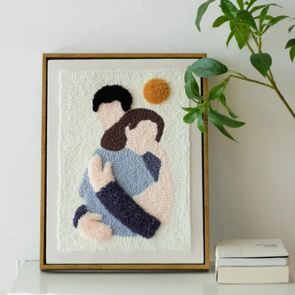 Punch needle hug art design featuring two figures embracing, framed as warm DIY wall decor or a sentimental handmade gift