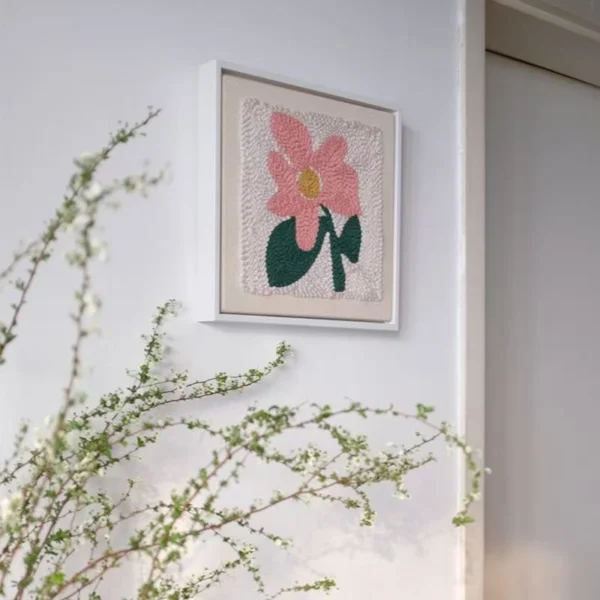 Framed punch needle pink flower embroidery kit hanging on wall, perfect for floral wall decor
