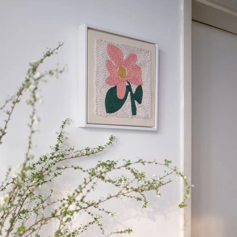 Framed punch needle pink flower embroidery kit hanging on wall, perfect for floral wall decor