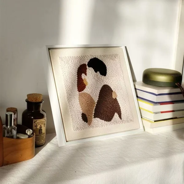Framed DIY punch needle artwork showing an abstract couple embracing — perfect romantic gift for handmade wall decor.