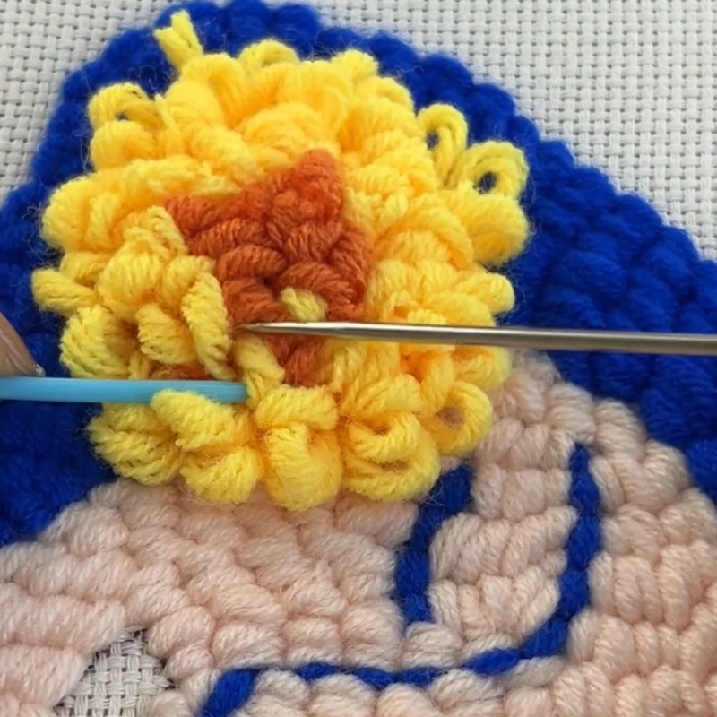 Refining layered yarn loops to enhance a 3D flower effect.