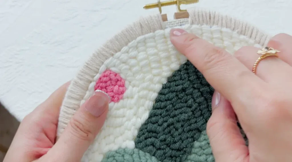 Returning to stitch around the hoop screw area after completing the rest.