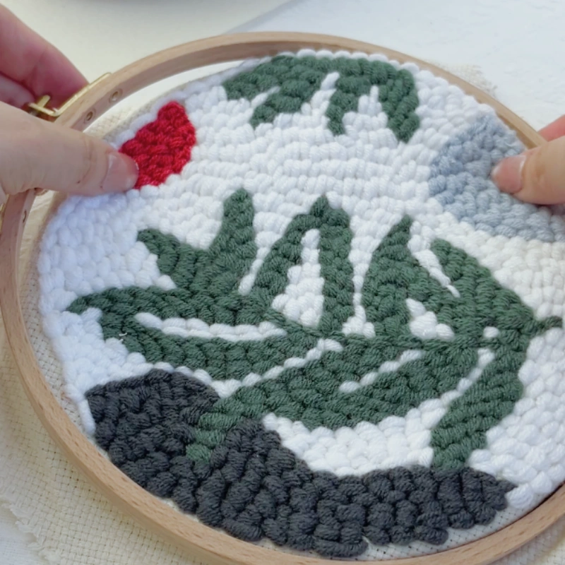 Separating the inner and outer rings of the embroidery hoop.