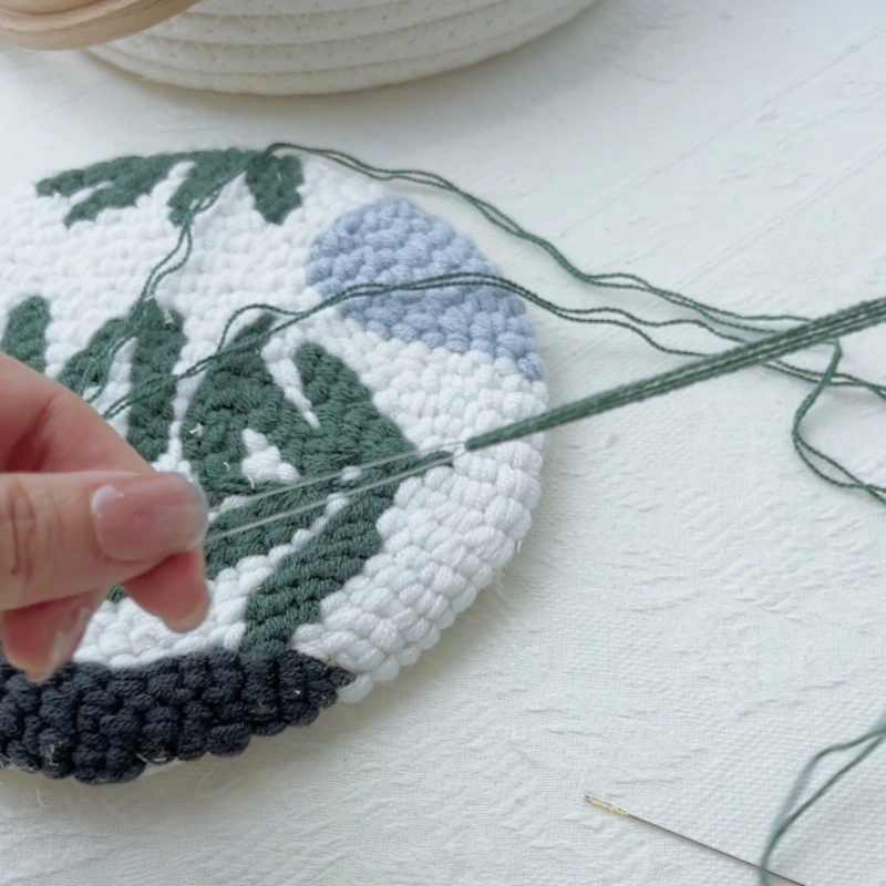 Looping yarn through the needle threader.